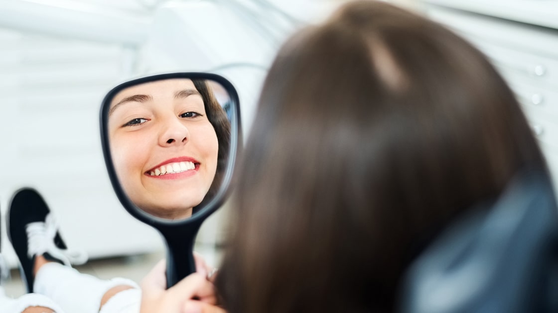 Girl Smiling with a Mirror Photo