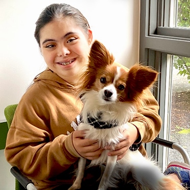 Teen Girl Holding Dog