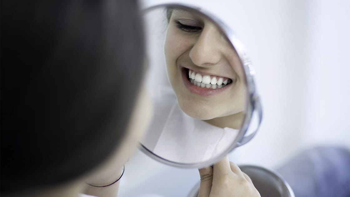 Girl smiling in mirror photo